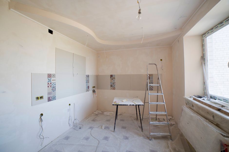 Plumber relocating soil pipe during a complete bathroom renovation in Bootle, Merseyside