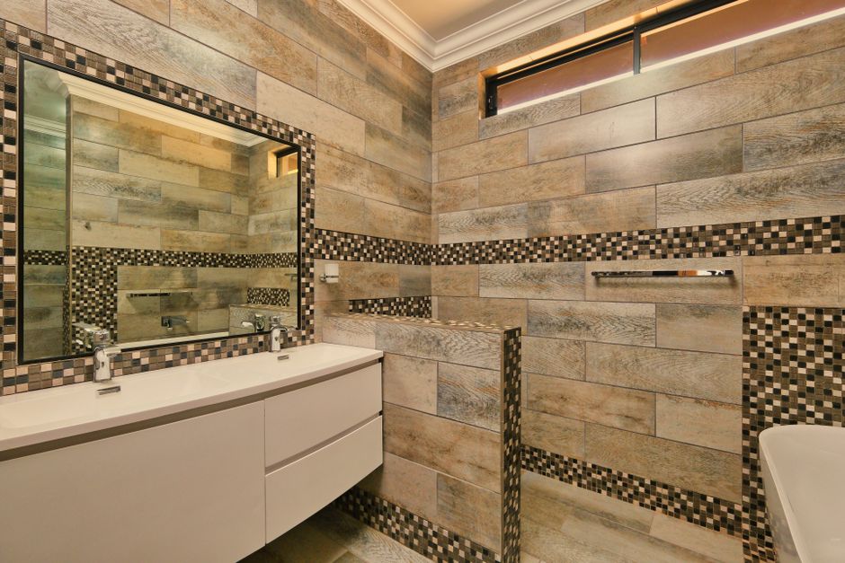 Completed new bathroom installation in Aintree showing full tiled family bathroom with walk-in shower and bath