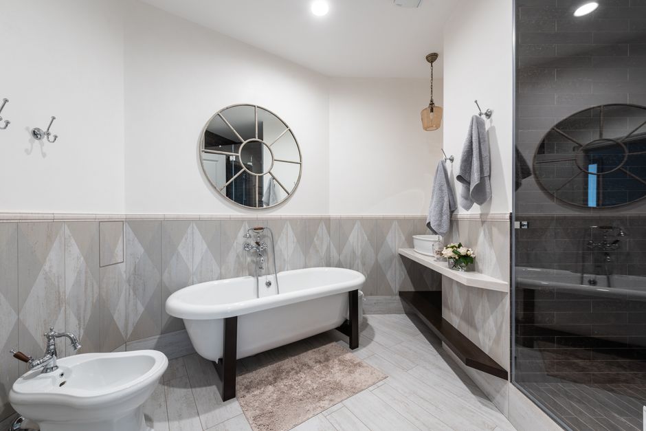 Freestanding vs built-in bath comparison in a UK bathroom renovation showing both styles side by side