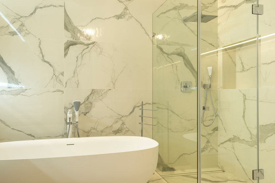 Fully tiled wet room with linear floor drain — comparing wet room vs standard bathroom cost in the UK